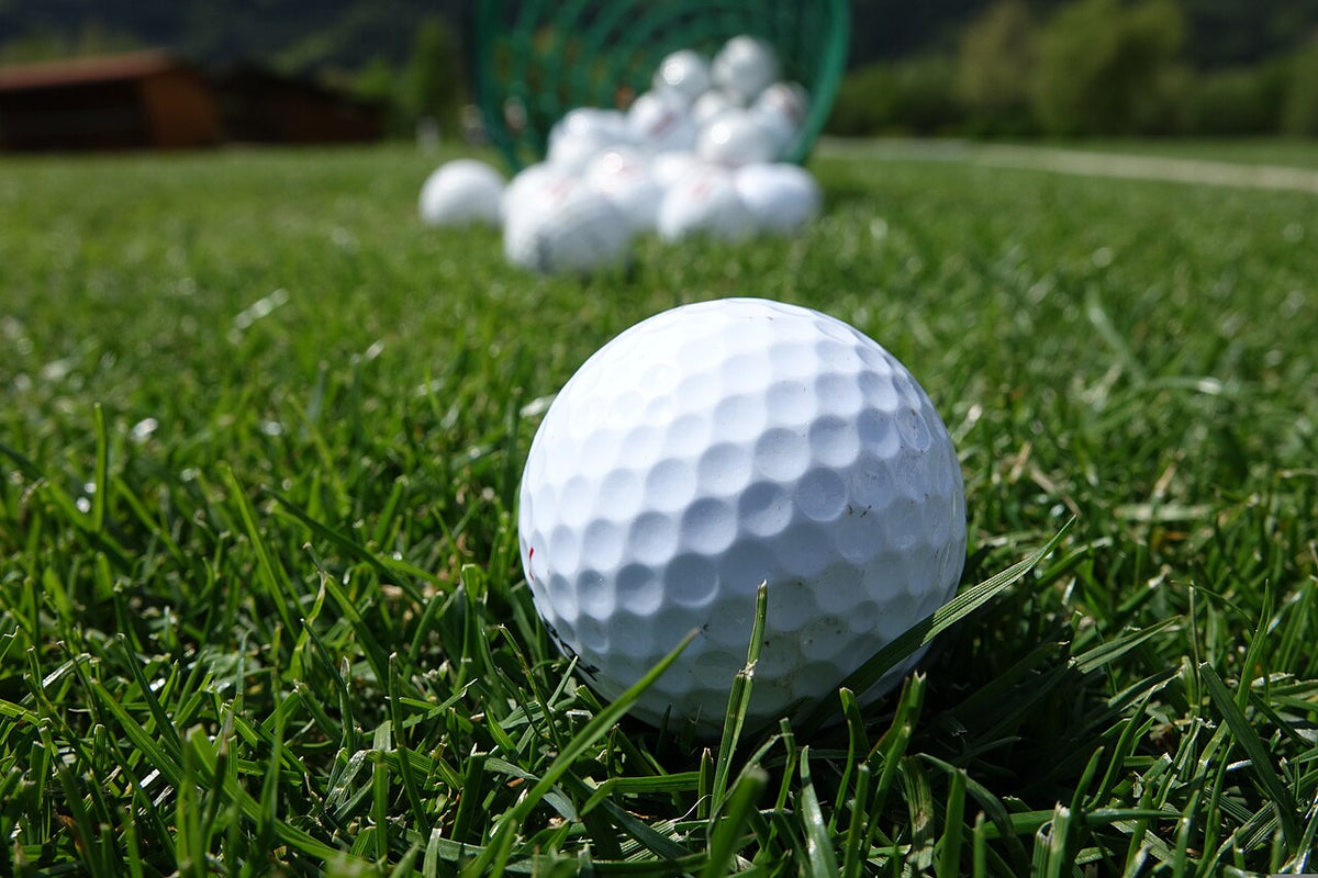 Golf ball on grass at a driving range; photo by Semevent, CC0 1.0