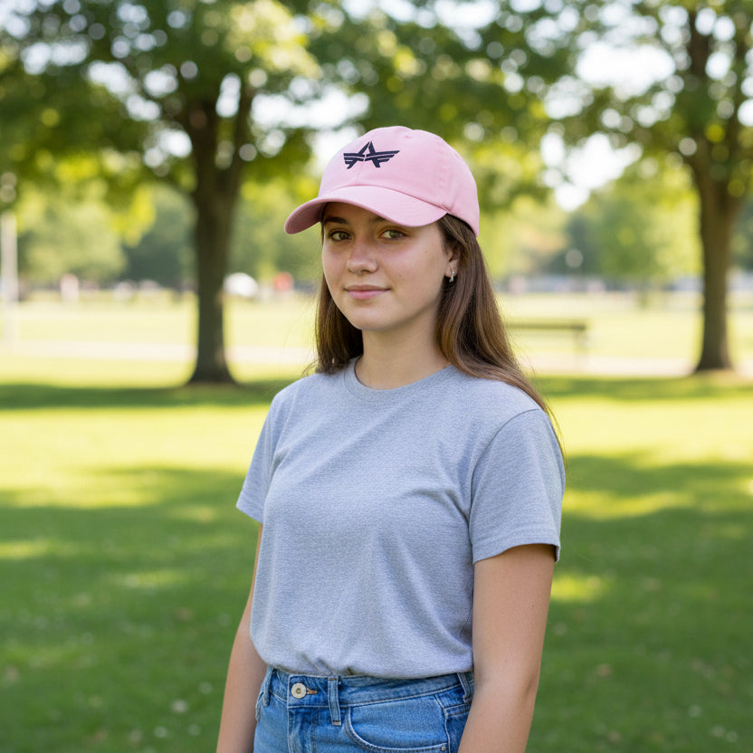 Youth cotton cap with embroidered emblem, curved visor, and adjustable strap